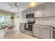 Charming kitchen with gray cabinets, modern appliances, and a cozy breakfast nook for casual dining at 4167 Capland Ave, Clermont, FL 34711