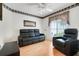 Comfortable living room with wood laminate flooring and large windows with a ceiling fan at 4167 Capland Ave, Clermont, FL 34711