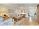 Bright living room featuring hardwood floors, floral sofa, and neutral paint at 4167 Capland Ave, Clermont, FL 34711