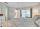 The main bedroom features a view of the lanai, carpet and a white dresser at 4167 Capland Ave, Clermont, FL 34711