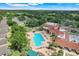 Aerial view showcases a large community pool with ample seating and a nearby clubhouse at 4167 Capland Ave, Clermont, FL 34711
