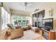 Cozy sunroom featuring comfortable wicker furniture, ceiling fan, and sliding glass doors at 4167 Capland Ave, Clermont, FL 34711