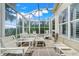 Bright sunroom featuring patio seating and a screened enclosure at 4167 Capland Ave, Clermont, FL 34711