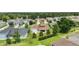 Aerial view showcasing the home's backyard, solar panels, mature landscaping and the surrounding neighborhood at 4320 Heritage Trl, Leesburg, FL 34748
