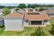Beautiful backyard with solar panels, a covered patio, and a lush lawn at 4320 Heritage Trl, Leesburg, FL 34748
