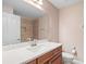 Bathroom featuring a white countertop, wood cabinets, a sink, and a mirror at 4320 Heritage Trl, Leesburg, FL 34748