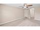 Bedroom with neutral colored walls, carpet, ceiling fan, and a hallway entrance at 4320 Heritage Trl, Leesburg, FL 34748
