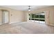 A spacious bedroom with carpet, ceiling fan, and sliding glass doors to the outside patio at 4320 Heritage Trl, Leesburg, FL 34748