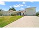 Lovely home with a three-car garage, lush lawn, and a beautiful garden at 4320 Heritage Trl, Leesburg, FL 34748