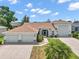 Attractive single-Gathering home featuring a three-car garage and a meticulously landscaped front yard at 4320 Heritage Trl, Leesburg, FL 34748