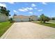 Charming single-story home with a large driveway and well-maintained landscaping at 4320 Heritage Trl, Leesburg, FL 34748