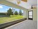 Screened lanai with tile flooring and view of backyard with trees at 4320 Heritage Trl, Leesburg, FL 34748