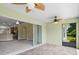 Screened lanai with tile flooring and view of backyard and kitchen at 4320 Heritage Trl, Leesburg, FL 34748