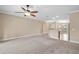 Open living room featuring neutral carpet, walls, and ceiling fan at 4320 Heritage Trl, Leesburg, FL 34748