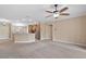 Open living space, with kitchen view, neutral walls and ceiling fan at 4320 Heritage Trl, Leesburg, FL 34748