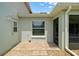A patio area outside features a door, window and tiling at 4320 Heritage Trl, Leesburg, FL 34748
