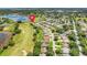 Aerial view of a home in a golf community, near a lake with mature trees and manicured lawns at 4720 Summerbridge Cir, Leesburg, FL 34748