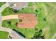 Aerial view of a home, showing the roof, driveway, and surrounding lush green landscape at 4720 Summerbridge Cir, Leesburg, FL 34748