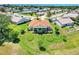 The back of a one-story home with a lanai overlooking a well-manicured backyard in a golf course community at 4720 Summerbridge Cir, Leesburg, FL 34748