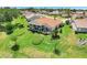 The back of a one-story home featuring a screened in lanai and lush, landscaped backyard at 4720 Summerbridge Cir, Leesburg, FL 34748