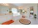 Relaxing bathroom features a soaking tub, dual sinks, and a large mirror at 4720 Summerbridge Cir, Leesburg, FL 34748