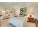 Bedroom with a ceiling fan, mirrored closet, and bedside tables with lamps at 4720 Summerbridge Cir, Leesburg, FL 34748