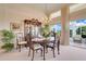 Elegant dining area with chandelier, china cabinet, and views of the lush outdoors at 4720 Summerbridge Cir, Leesburg, FL 34748