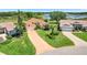 Aerial view of a well-maintained one-story home with manicured landscaping and a long driveway at 4720 Summerbridge Cir, Leesburg, FL 34748