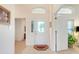 Elegant front door with decorative glass, sidelight, and transom window, set on tile flooring at 4720 Summerbridge Cir, Leesburg, FL 34748