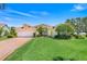Beautiful one-story home with a manicured lawn, mature landscaping, and an attached two-car garage at 4720 Summerbridge Cir, Leesburg, FL 34748