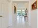Bright hallway with tile flooring leading to a spacious living area with scenic views at 4720 Summerbridge Cir, Leesburg, FL 34748