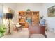 Home office with a large desk, bookshelves, and comfortable seating at 4720 Summerbridge Cir, Leesburg, FL 34748