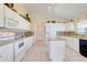 Spacious kitchen featuring white cabinetry, granite countertops, and stainless steel appliances at 4720 Summerbridge Cir, Leesburg, FL 34748