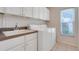 Laundry room with a washer, dryer, sink, and ample cabinet space at 4720 Summerbridge Cir, Leesburg, FL 34748