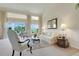Bright living room with large windows, elegant furnishings, and lush outdoor views at 4720 Summerbridge Cir, Leesburg, FL 34748