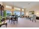 Open living area with dining space, large windows showcasing water views, and elegant furnishings at 4720 Summerbridge Cir, Leesburg, FL 34748
