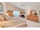 Vaulted ceiling main bedroom featuring a king bed, window views, and light wood furniture at 4720 Summerbridge Cir, Leesburg, FL 34748