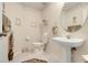 Elegant powder room with pedestal sink, decorative mirror, and neutral color scheme at 4720 Summerbridge Cir, Leesburg, FL 34748