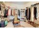Organized walk-in closet with multiple shelving units and racks for ample storage at 4720 Summerbridge Cir, Leesburg, FL 34748