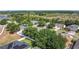 An aerial view of a neighborhood featuring well-maintained homes with mature trees and landscaping at 4908 Cape Hatteras Dr, Clermont, FL 34714