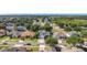 Overhead view showcases a vibrant neighborhood with manicured lawns and tree-lined streets at 4908 Cape Hatteras Dr, Clermont, FL 34714