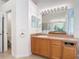 Vanity area in the bathroom features a spacious countertop and wood cabinetry at 4908 Cape Hatteras Dr, Clermont, FL 34714