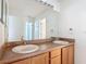 Bathroom featuring double sinks, vanity cabinet, a large mirror, and brushed fixtures at 4908 Cape Hatteras Dr, Clermont, FL 34714