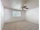 Carpeted bedroom featuring a ceiling fan and a bright window with backyard view at 4908 Cape Hatteras Dr, Clermont, FL 34714