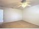 Bright, neutral-toned bedroom with carpet flooring and a ceiling fan at 4908 Cape Hatteras Dr, Clermont, FL 34714