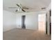 Carpeted bedroom with a ceiling fan and access to additional rooms at 4908 Cape Hatteras Dr, Clermont, FL 34714