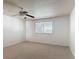 Bedroom featuring neutral carpet, ceiling fan, and natural light from the window at 4908 Cape Hatteras Dr, Clermont, FL 34714