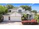 Charming two-story home with a three car garage, manicured landscaping, and a welcoming front entrance at 4908 Cape Hatteras Dr, Clermont, FL 34714