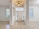 Front Foyer showcasing columns, a tray ceiling, and a front door with sidelights at 4908 Cape Hatteras Dr, Clermont, FL 34714