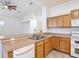 Kitchen featuring a breakfast bar, wood cabinets, and stainless-steel sink at 4908 Cape Hatteras Dr, Clermont, FL 34714